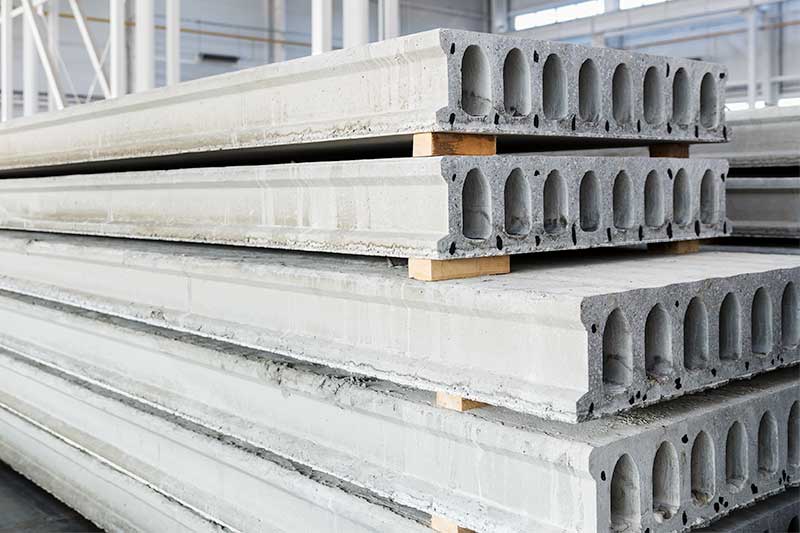 Hollow-core precast concrete units stacked in a pre-cast concrete yard