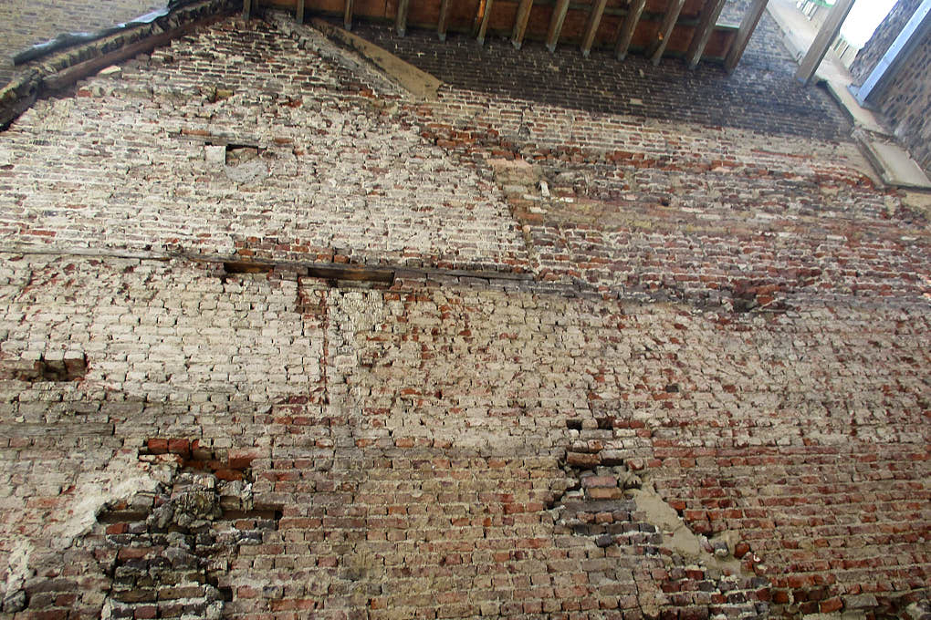 Inside a building stripped back to brickwork