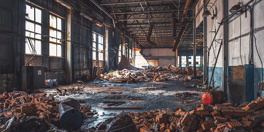 Interior of building strewn with debris and rubbish awaiting demolition or refurbishment