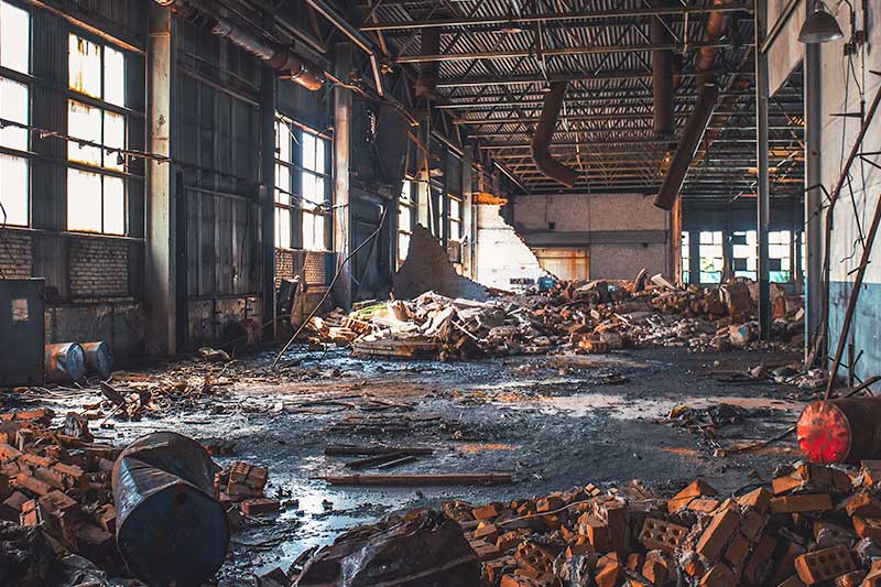 Interior of building strewn with debris and rubbish awaiting demolition or refurbishment