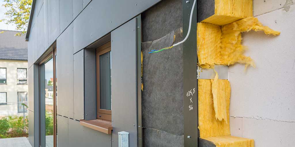 Cladding panels removed, exposing Insulation fitted to the external building facade
