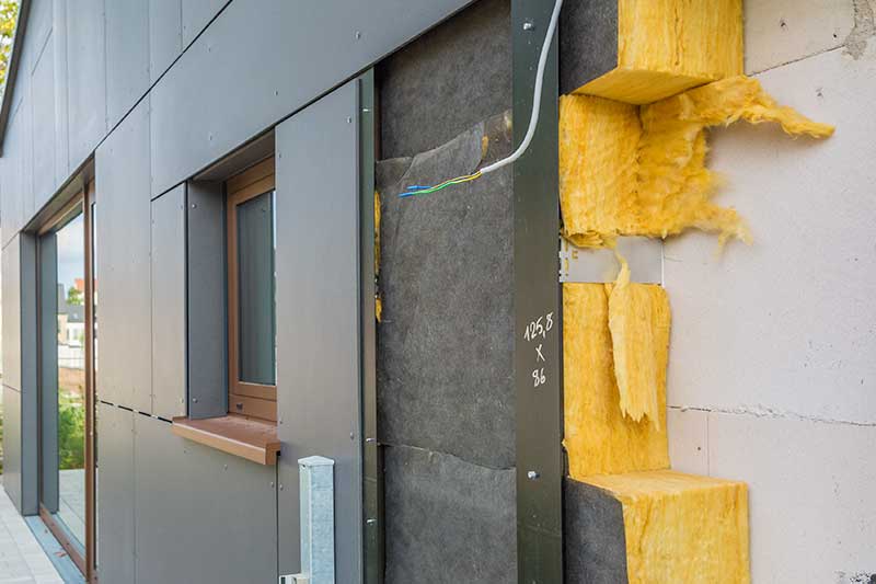 Cladding panels removed, exposing Insulation fitted to the external building facade