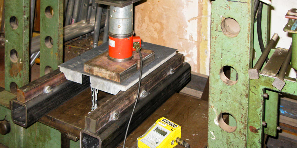 Manhole cover being load tested in the laboratory
